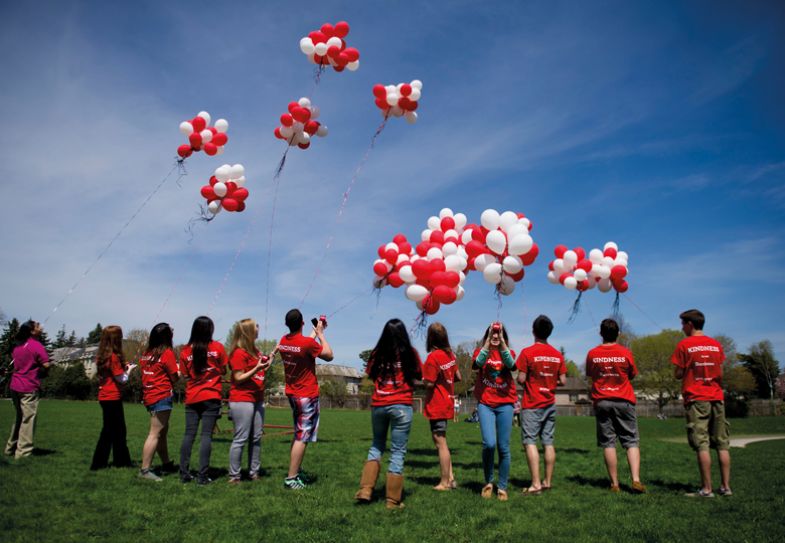 Students release a thousand biodegradable helium balloons and flying them as kites to create create a happy, supportive environment in Toronto Students release a thousand biodegradable helium balloons and flying them as kites to create create a happy, supportive environment in Toronto